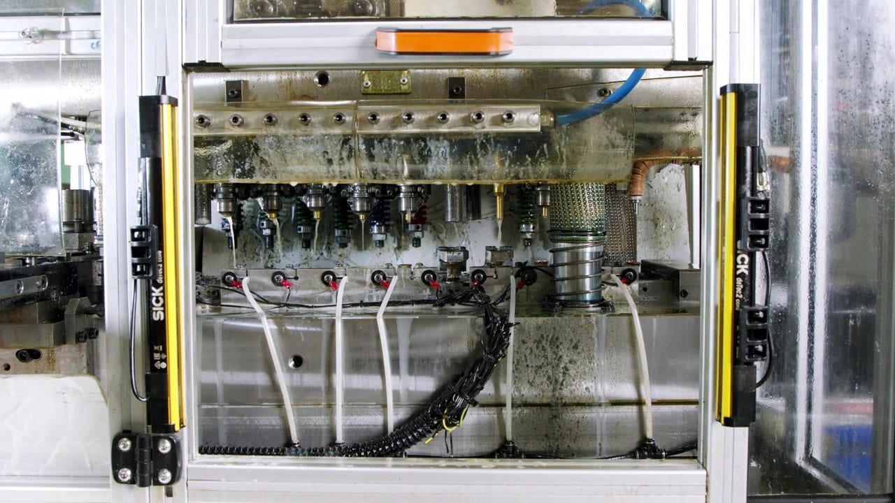 Inside view of an injection molding machine showing nozzles and the molding station