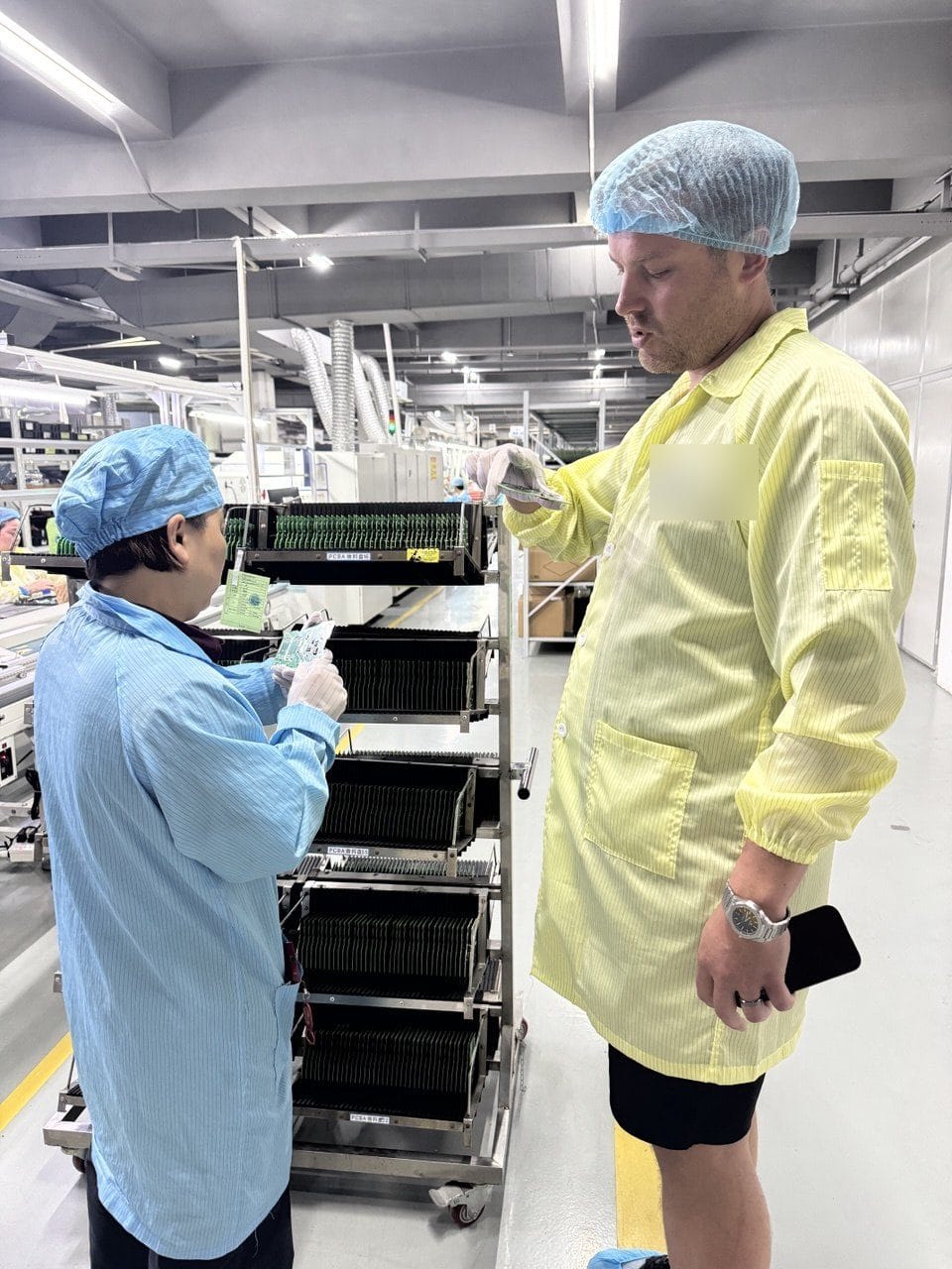 Union Delta inspecting a rack of assembled boards on the production floor
