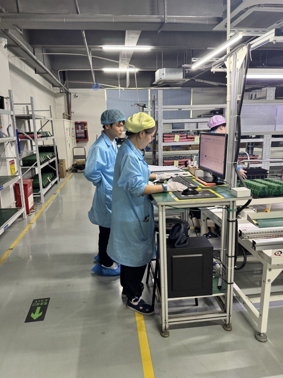 Operators at an in-line functional test and inspection station