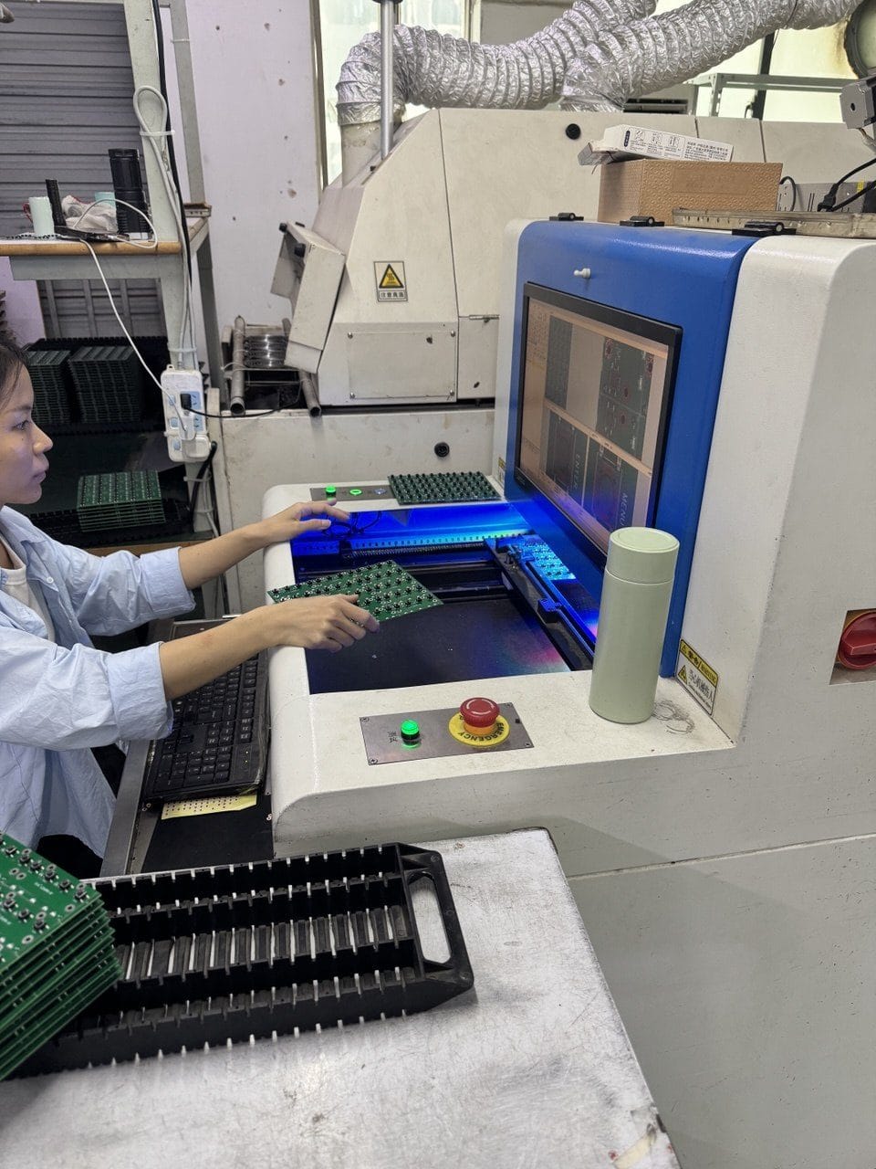 An operator running boards through an automated optical inspection machine