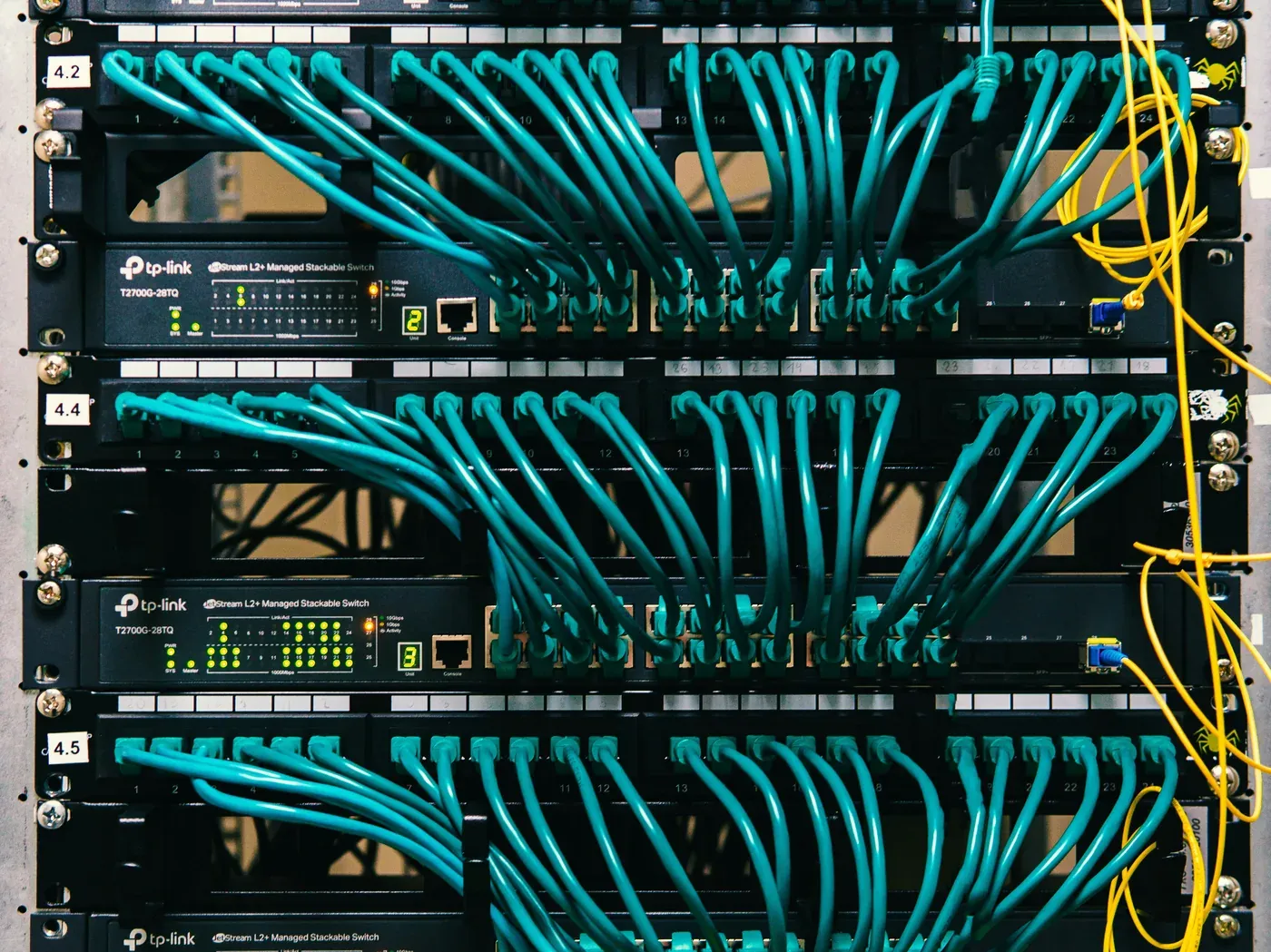 Server rack in a colocation cabinet with network switches and patch cables
