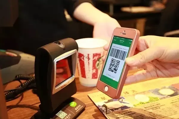 WeChat Pay QR code scanning at merchant payment terminal in China